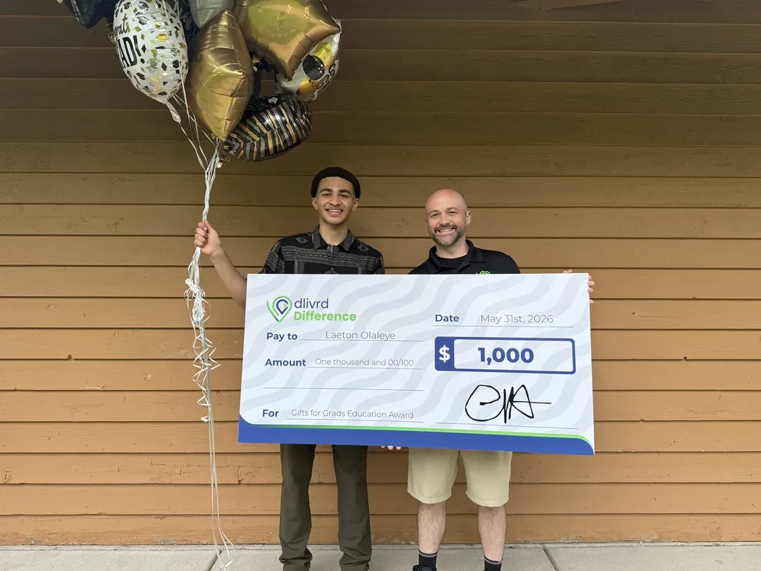 A Gifts for Grads scholarship recipient with an oversized award check