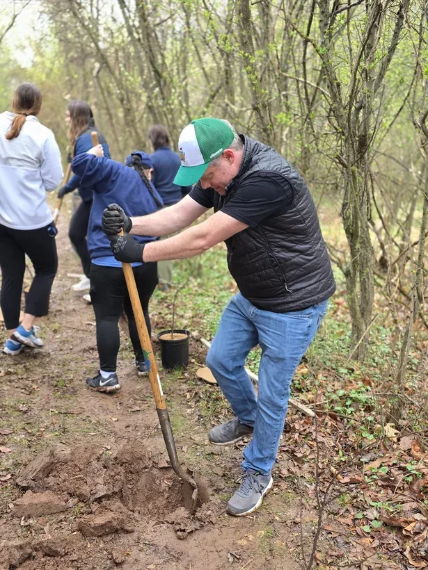 Volunteers planting trees at a dlivrd Difference community day